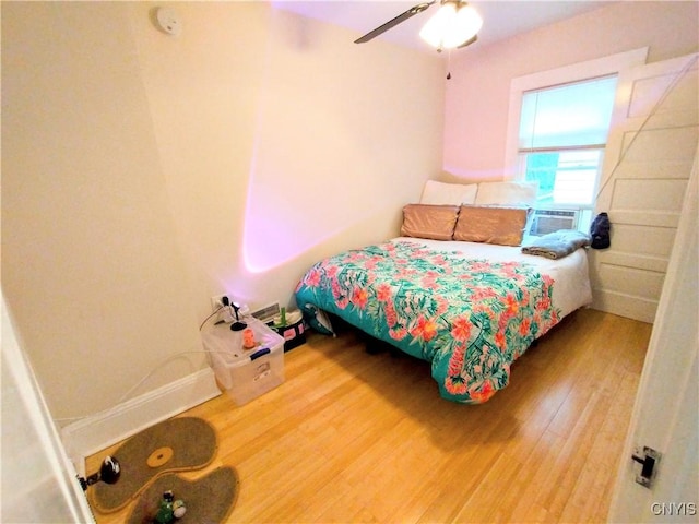 bedroom with wood finished floors and a ceiling fan