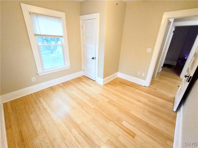 unfurnished bedroom featuring baseboards and light wood finished floors