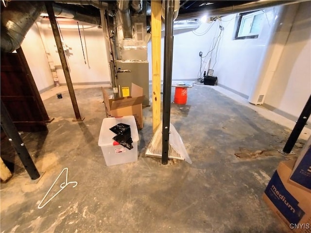 basement featuring heating unit and baseboards