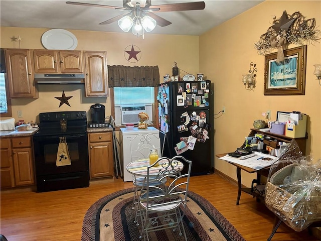 99 N Main St, Mount Morris, NY 14510 - kitchen with black appliances, washer / clothes dryer, under cabinet range hood, light wood finished floors, and a ceiling fan