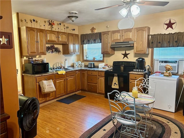 99 N Main St, Mount Morris, NY 14510 - kitchen featuring black appliances, under cabinet range hood, ceiling fan, a sink, and cooling unit