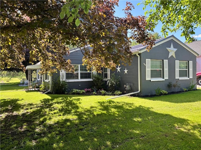 99 N Main St, Mount Morris, NY 14510 - view of front of house with a front lawn and concrete block siding