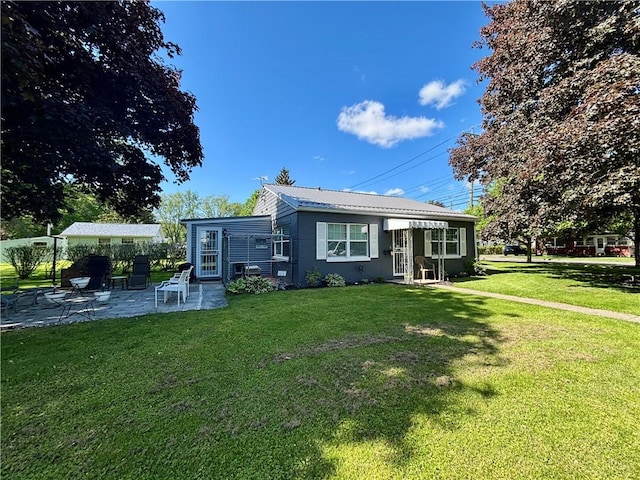 99 N Main St, Mount Morris, NY 14510 - view of front of house featuring a patio area, a front lawn, and metal roof