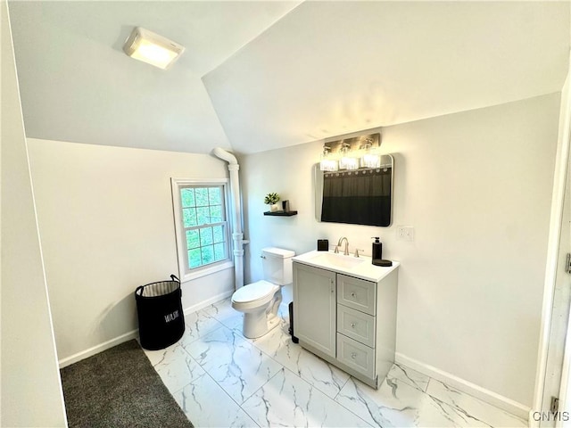 bathroom with baseboards, marble finish floors, toilet, vanity, and lofted ceiling