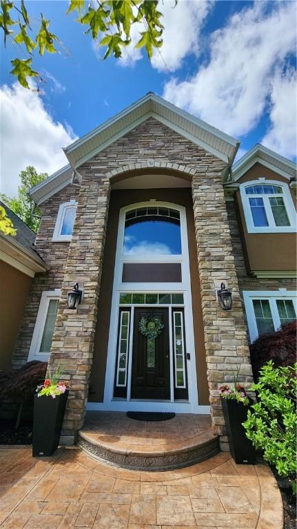 31 Putney Pl, Greece, NY 14468 - doorway to property featuring stone siding