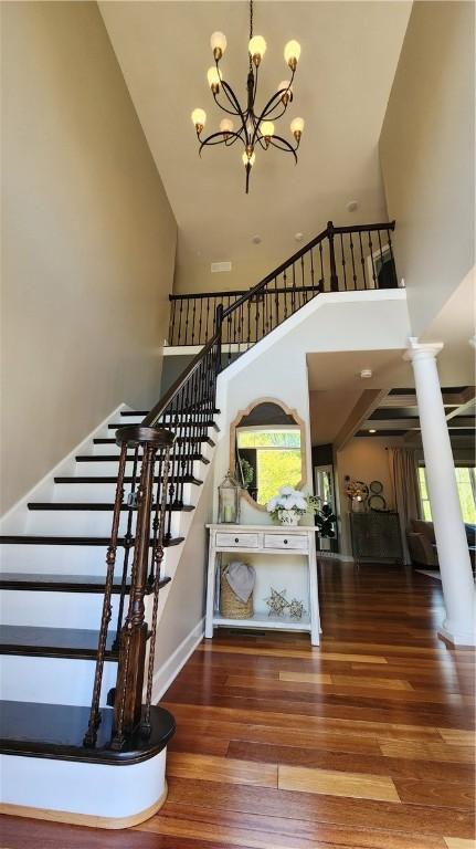31 Putney Pl, Greece, NY 14468 - stairway with a towering ceiling, a chandelier, plenty of natural light, wood finished floors, and baseboards