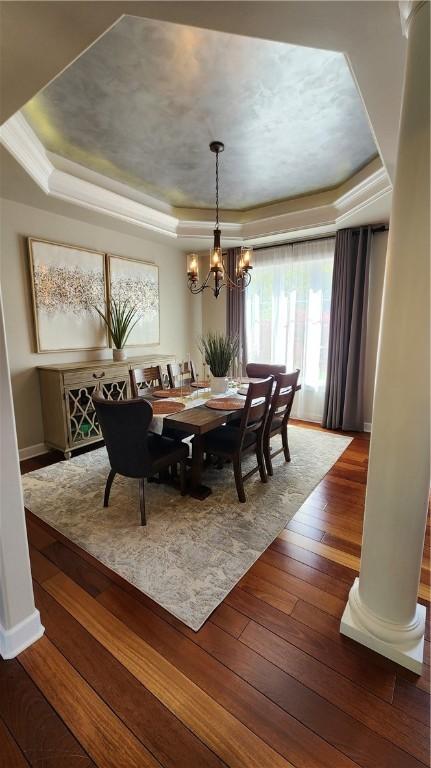 31 Putney Pl, Greece, NY 14468 - dining space with a raised ceiling, a chandelier, hardwood / wood-style flooring, and plenty of natural light