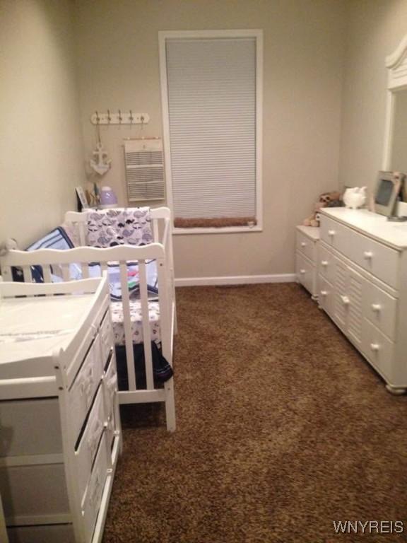 9 N Hartland St, Royalton, NY 14105 - bedroom with dark colored carpet and baseboards