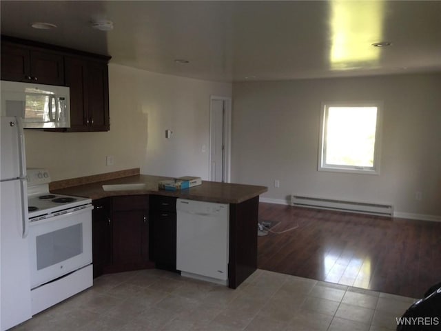9 N Hartland St, Royalton, NY 14105 - kitchen featuring white appliances, a baseboard radiator, a peninsula, open floor plan, and light tile patterned floors