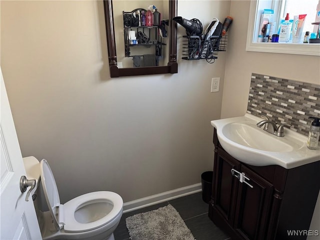 9 N Hartland St, Royalton, NY 14105 - half bath featuring toilet, vanity, decorative backsplash, and baseboards