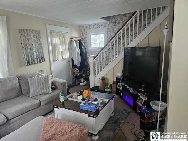 69 Royal Ave, Jamestown, NY 14701 - living room featuring stairs, ornamental molding, and carpet