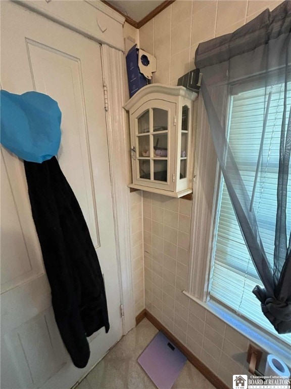69 Royal Ave, Jamestown, NY 14701 - bathroom featuring tile walls, tile patterned flooring, and ornamental molding