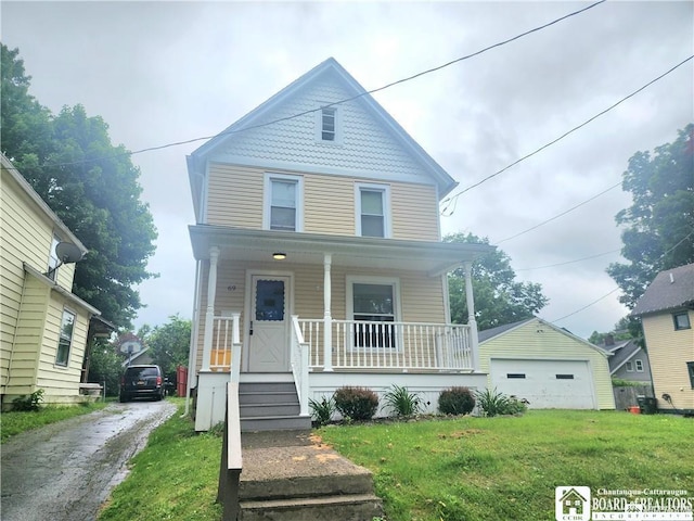 69 Royal Ave, Jamestown, NY 14701 - victorian house with covered porch, a front yard, and a garage