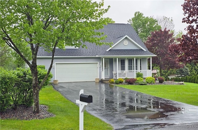 108 Sunflower Cir, Frankfort, NY 13340 - view of front of home featuring covered porch, asphalt driveway, a shingled roof, a front lawn, and a garage
