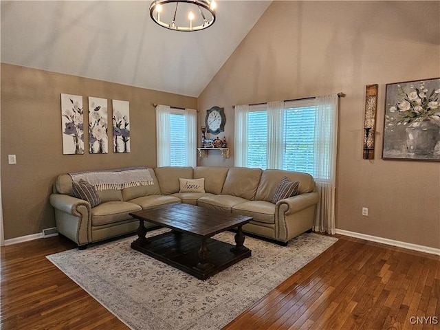108 Sunflower Cir, Frankfort, NY 13340 - living room featuring high vaulted ceiling, dark wood-style floors, baseboards, and a chandelier