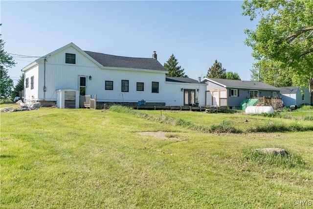 20304 Burton Rd, Hounsfield, NY 13685 - rear view of property featuring a chimney and a lawn