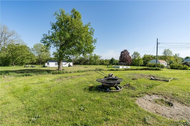 20304 Burton Rd, Hounsfield, NY 13685 - view of grassy yard featuring a fire pit