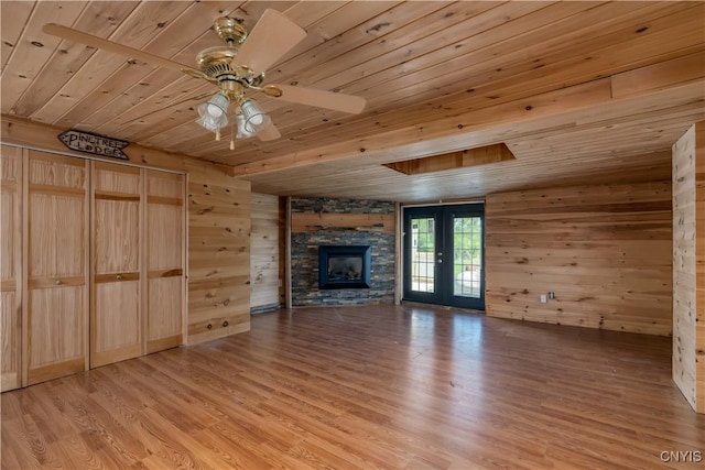 20304 Burton Rd, Hounsfield, NY 13685 - unfurnished living room featuring wooden ceiling, a fireplace, light wood finished floors, wooden walls, and a ceiling fan