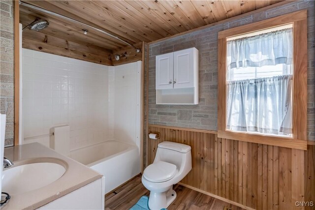 20304 Burton Rd, Hounsfield, NY 13685 - full bathroom with toilet, wooden walls, wood finished floors, shower / tub combination, and wainscoting