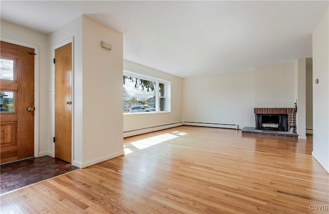 18 Court Knolle, New Hartford, NY 13413 - unfurnished living room with light wood-style flooring, a fireplace, baseboards, baseboard heating, and a baseboard heating unit