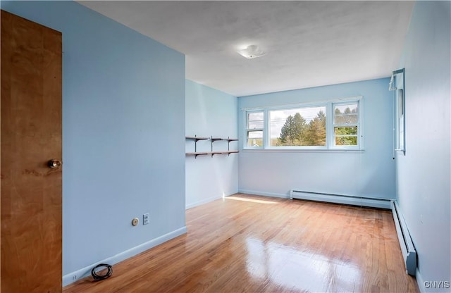 18 Court Knolle, New Hartford, NY 13413 - unfurnished room with baseboard heating, wood finished floors, and baseboards
