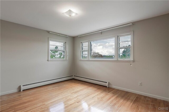 18 Court Knolle, New Hartford, NY 13413 - empty room with light wood-style flooring, baseboards, and baseboard heating