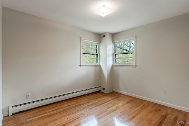 18 Court Knolle, New Hartford, NY 13413 - empty room featuring baseboard heating, light wood finished floors, and baseboards