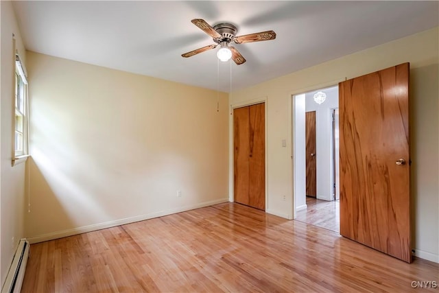 18 Court Knolle, New Hartford, NY 13413 - unfurnished bedroom with a baseboard heating unit, light wood-style flooring, baseboards, and a ceiling fan