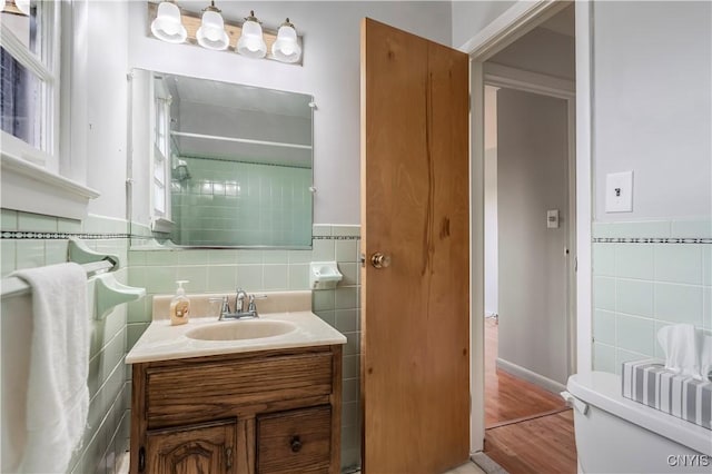 18 Court Knolle, New Hartford, NY 13413 - bathroom with tile walls, vanity, wood finished floors, toilet, and wainscoting