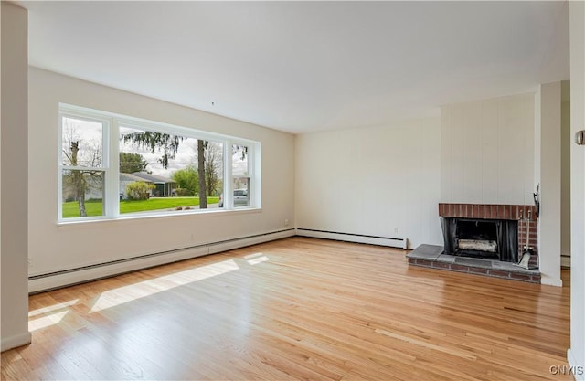18 Court Knolle, New Hartford, NY 13413 - unfurnished living room with light wood-style floors, baseboard heating, and a fireplace