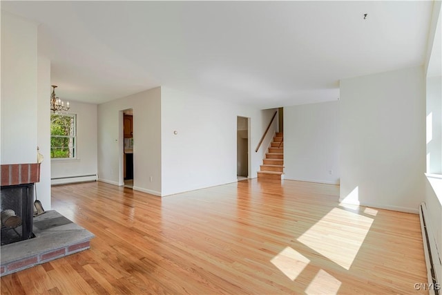 18 Court Knolle, New Hartford, NY 13413 - unfurnished living room with baseboard heating, stairs, and light wood finished floors