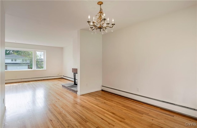 18 Court Knolle, New Hartford, NY 13413 - unfurnished room with baseboard heating, a chandelier, and light wood finished floors