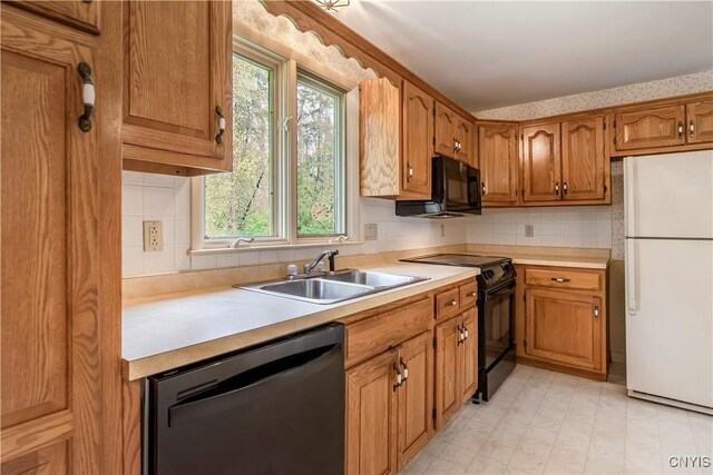 18 Court Knolle, New Hartford, NY 13413 - kitchen with black appliances, a sink, light countertops, brown cabinetry, and decorative backsplash