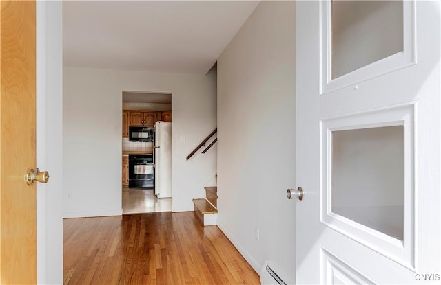 18 Court Knolle, New Hartford, NY 13413 - corridor with stairs, light wood-type flooring, and a baseboard heating unit