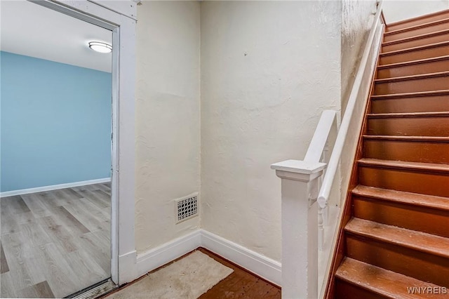 stairway featuring wood finished floors