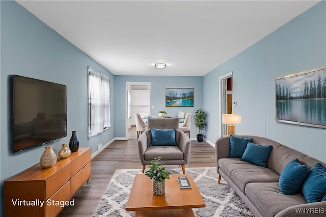 living room featuring baseboards and wood finished floors
