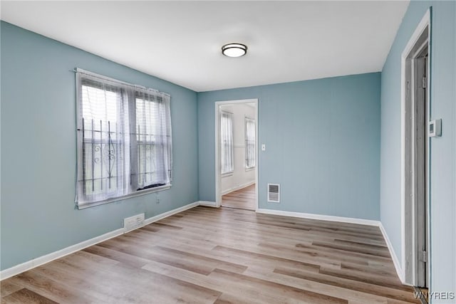 unfurnished room with wood finished floors and baseboards