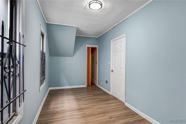 bonus room featuring wood finished floors and baseboards