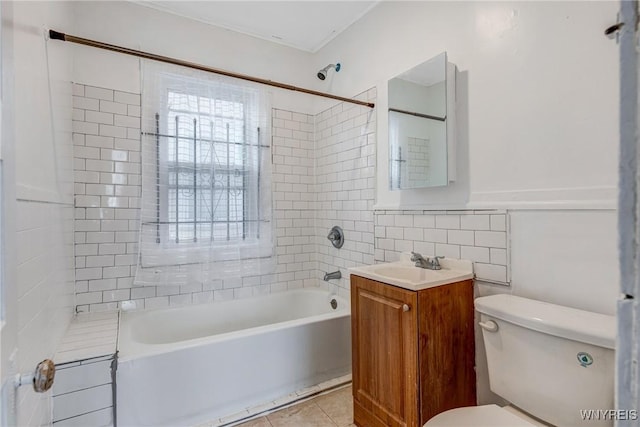 bathroom featuring toilet,  shower combination, tile walls, vanity, and tile patterned flooring