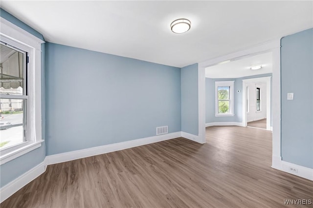 unfurnished room with wood finished floors and baseboards
