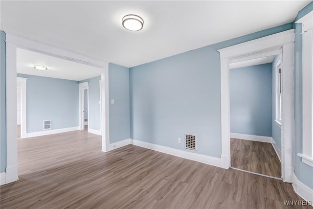 empty room with wood finished floors and baseboards