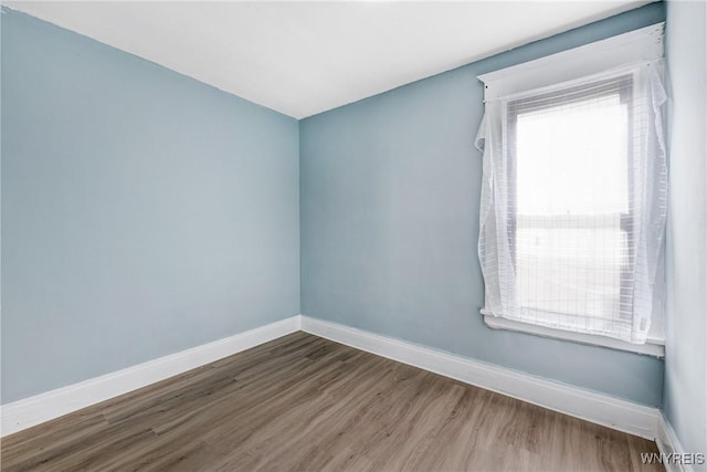 unfurnished room featuring wood finished floors and baseboards
