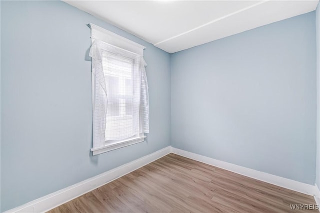 unfurnished room with wood finished floors and baseboards