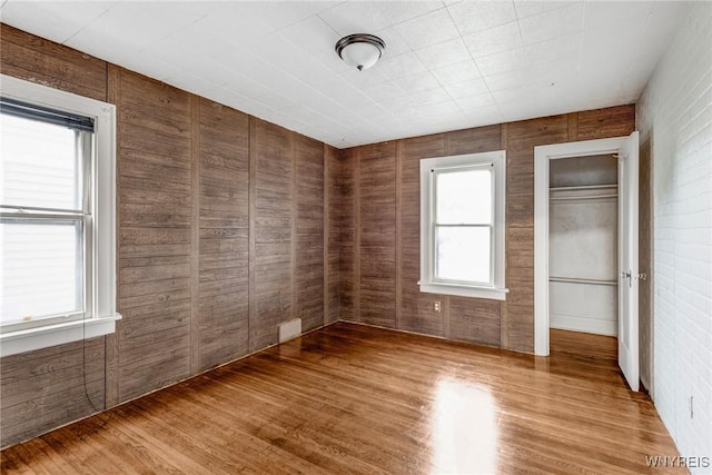 27 E End Ave, Cheektowaga, NY 14225 - unfurnished bedroom featuring light wood finished floors and wooden walls