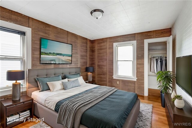 27 E End Ave, Cheektowaga, NY 14225 - bedroom with wooden walls and light wood-type flooring