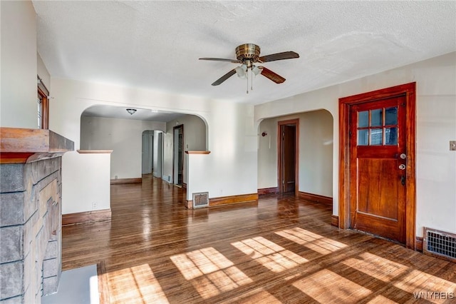 27 E End Ave, Cheektowaga, NY 14225 - unfurnished living room featuring arched walkways, a ceiling fan, wood finished floors, baseboards, and a textured ceiling
