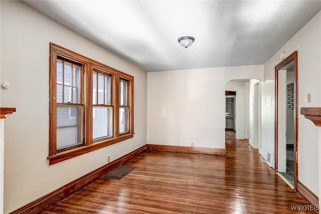 27 E End Ave, Cheektowaga, NY 14225 - unfurnished room featuring arched walkways, baseboards, and wood finished floors
