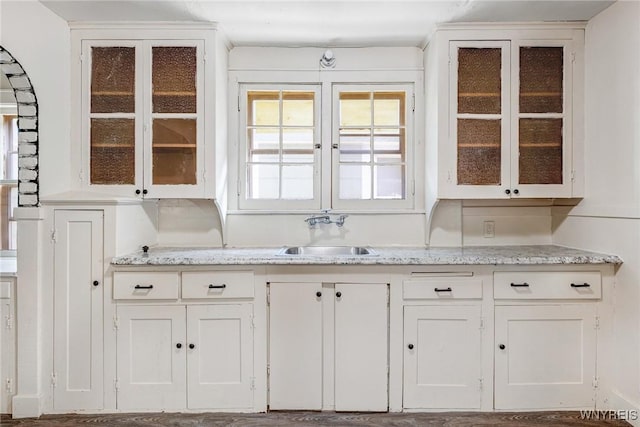 27 E End Ave, Cheektowaga, NY 14225 - kitchen with a sink, white cabinetry, and glass insert cabinets