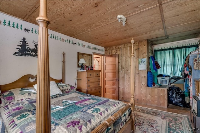 bedroom with wood ceiling, wooden walls, and wood finished floors