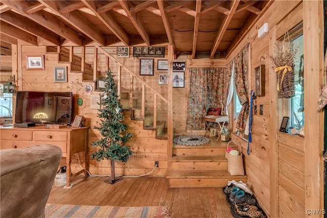 interior space featuring wood walls, hardwood / wood-style floors, and wooden ceiling